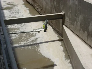 MonoScan mono-block ultrasonic level sensor mounted on a metal bracket for open channel water level and flow measurement